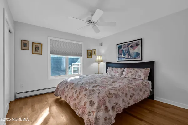 a bedroom with a bed a couch and a window