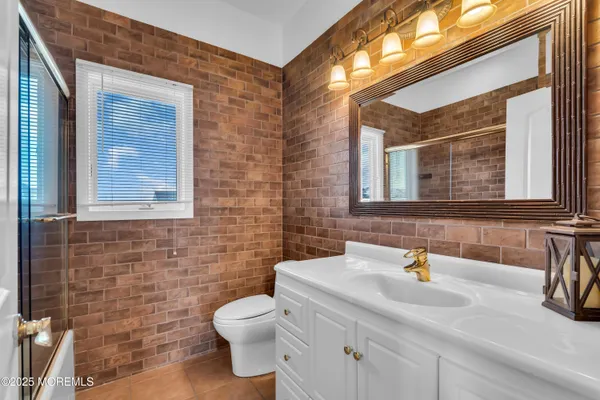 a bathroom with a shower and a sink