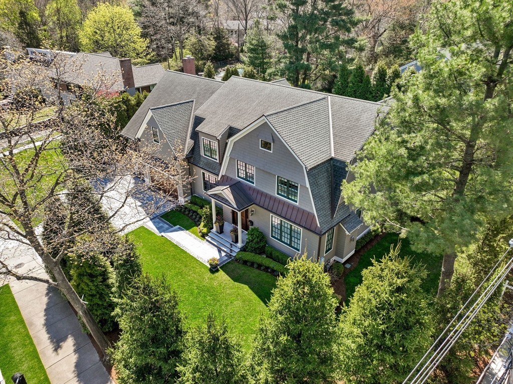 an aerial view of a house with a big yard and large trees