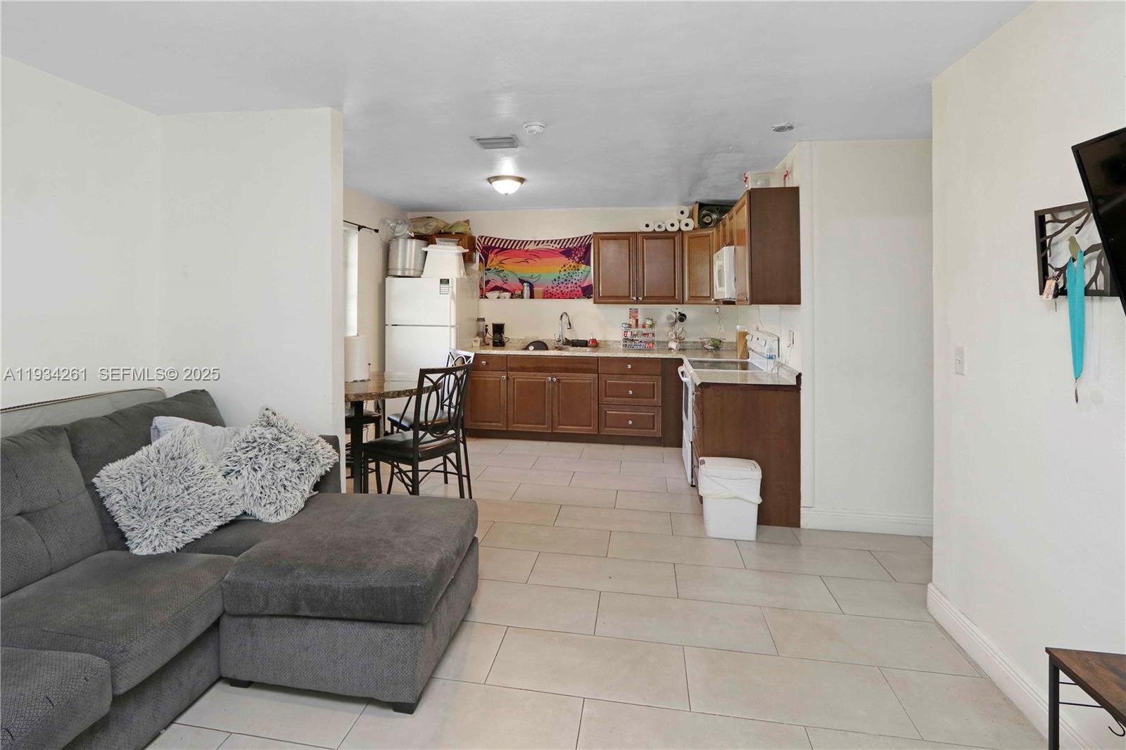 514 Northwest 21st Street Homestead, FL 33030 - Photo 12 of 45 a living room with furniture and a flat screen tv