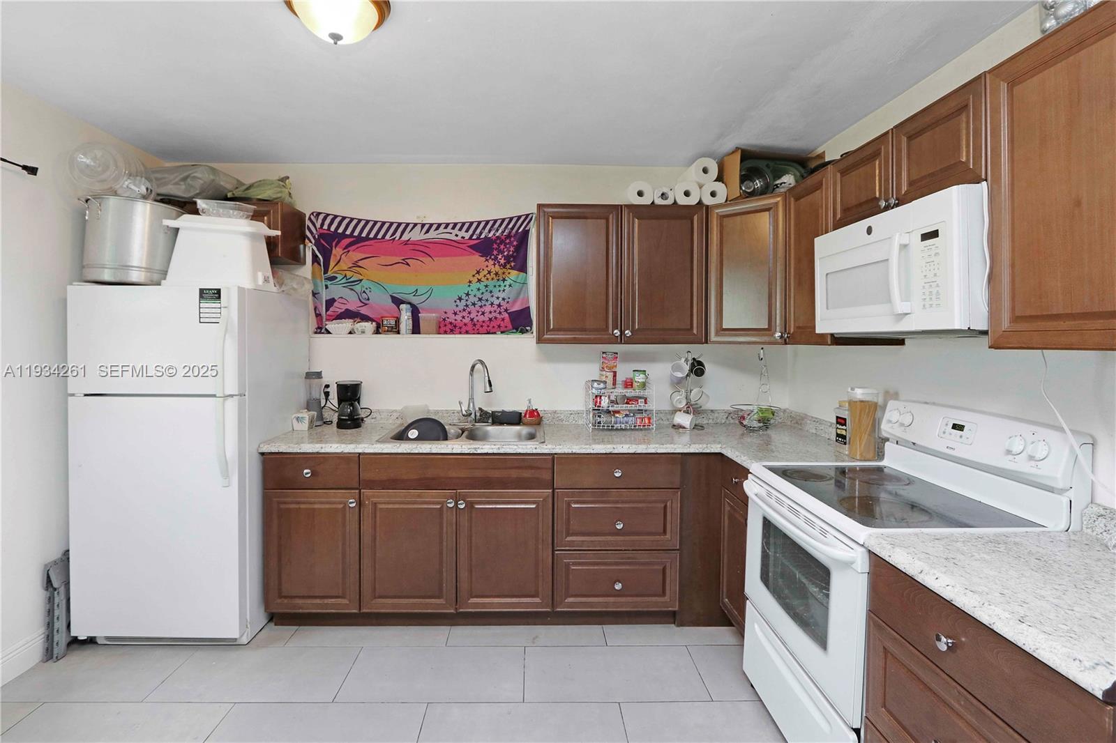 514 Northwest 21st Street Homestead, FL 33030 - Photo 14 of 45 a kitchen with stainless steel appliances granite countertop a refrigerator sink and cabinets