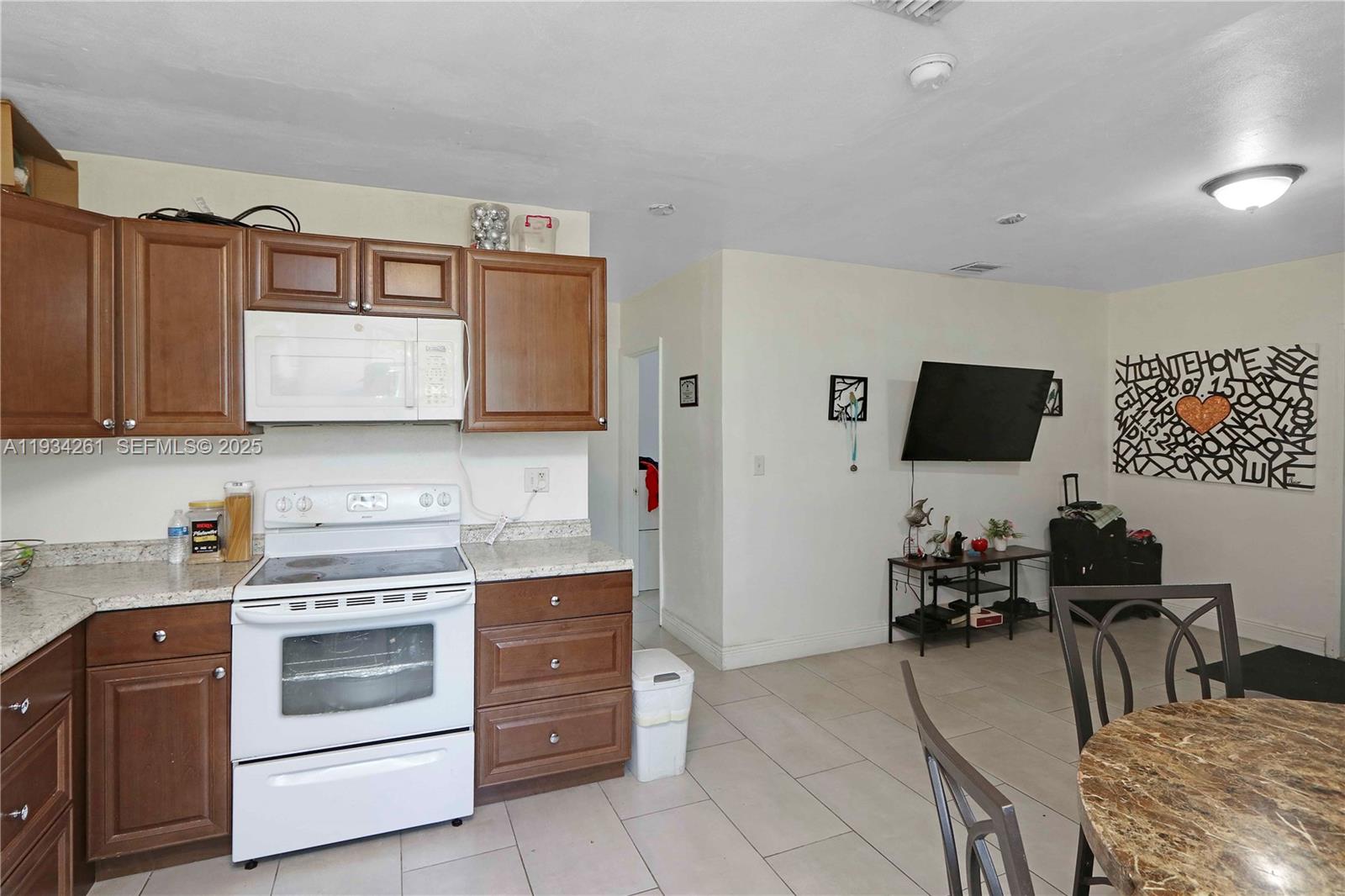 514 Northwest 21st Street Homestead, FL 33030 - Photo 16 of 45 a kitchen with stainless steel appliances a stove a microwave a sink and cabinets
