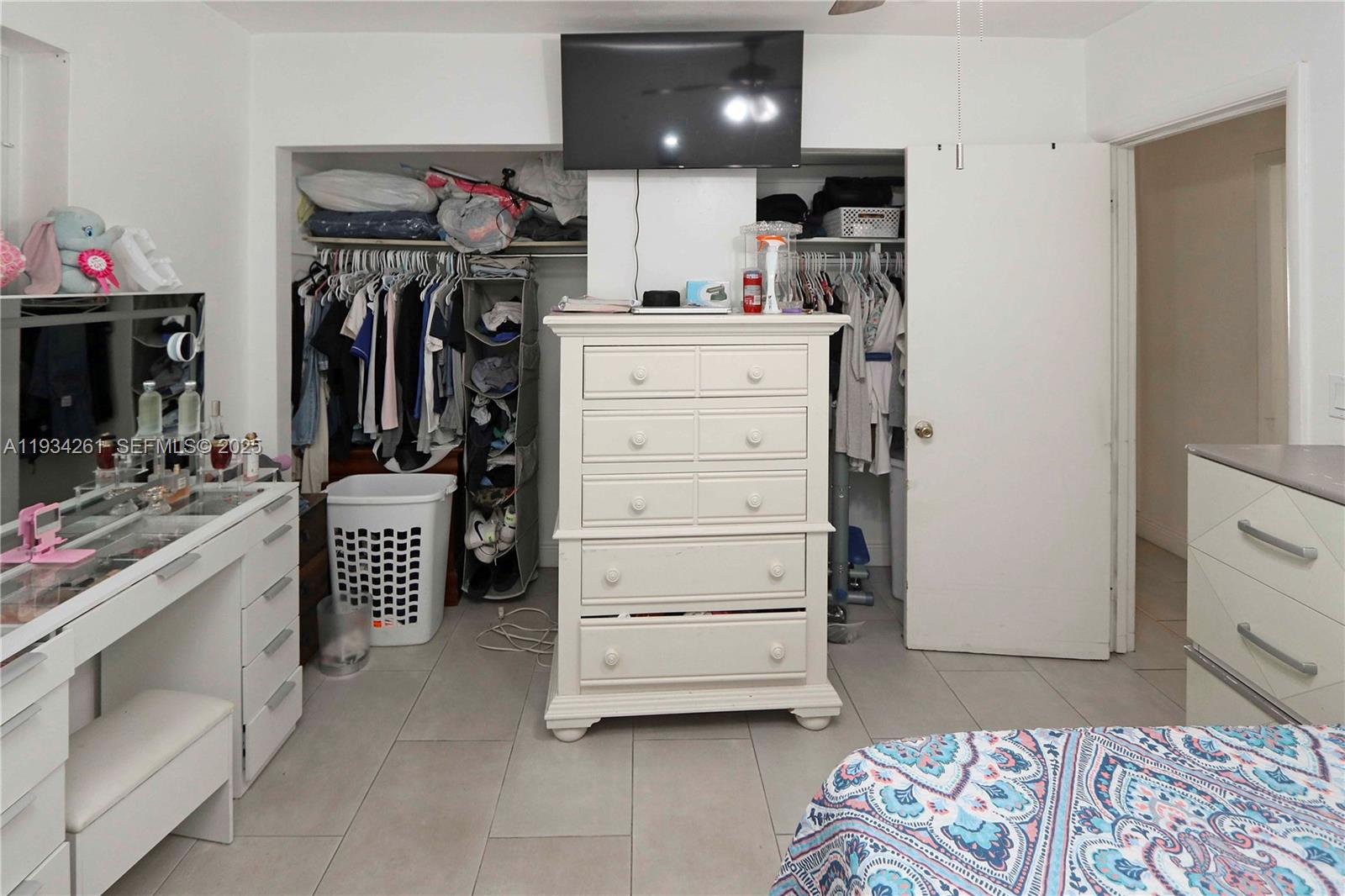 514 Northwest 21st Street Homestead, FL 33030 - Photo 18 of 45 a view of walk in closet with clothes and shoes