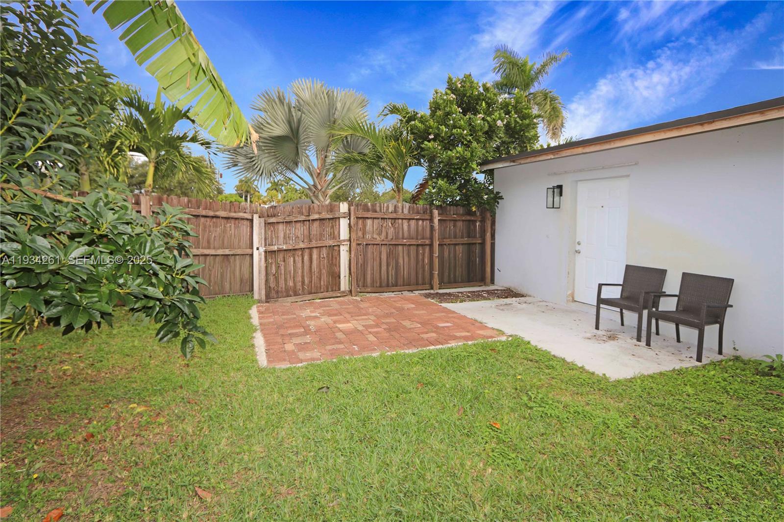 514 Northwest 21st Street Homestead, FL 33030 - Photo 20 of 45 a backyard of a house with table and chairs