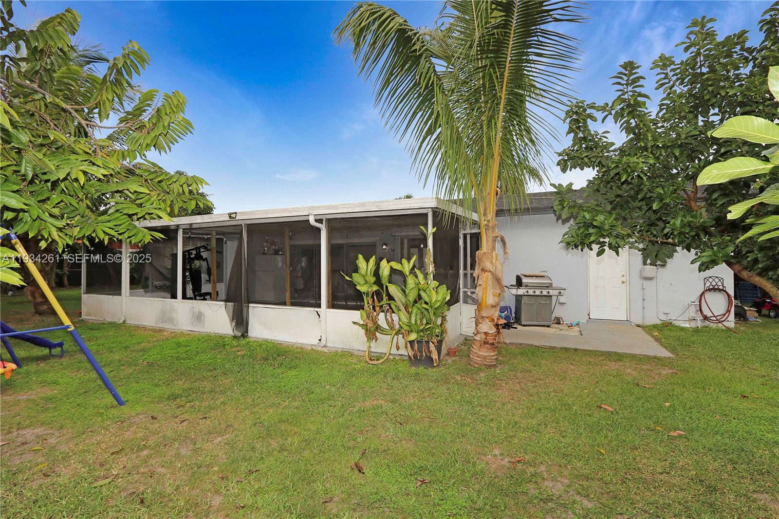 514 Northwest 21st Street Homestead, FL 33030 - Photo 25 of 45 a view of a house with a backyard porch and sitting area