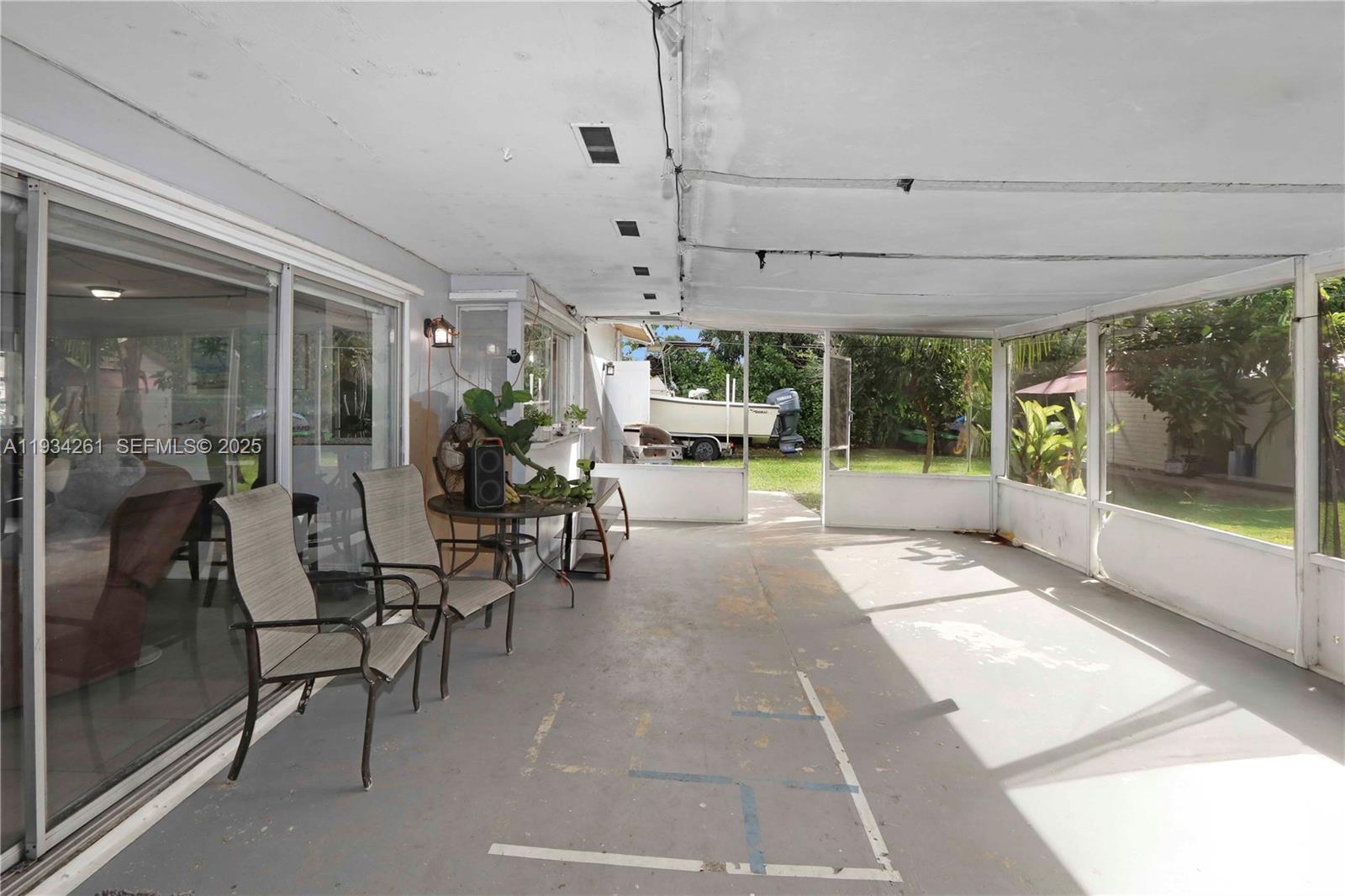514 Northwest 21st Street Homestead, FL 33030 - Photo 30 of 45 a view of a porch with dining table and chairs
