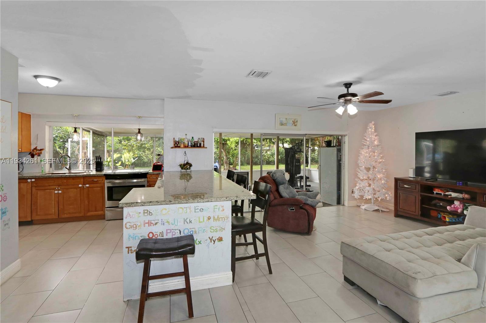 514 Northwest 21st Street Homestead, FL 33030 - Photo 32 of 45 a living room with furniture a flat screen tv and a large window