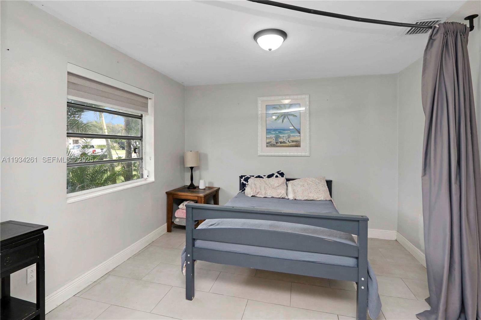 514 Northwest 21st Street Homestead, FL 33030 - Photo 38 of 45 a bedroom with a bed and a window