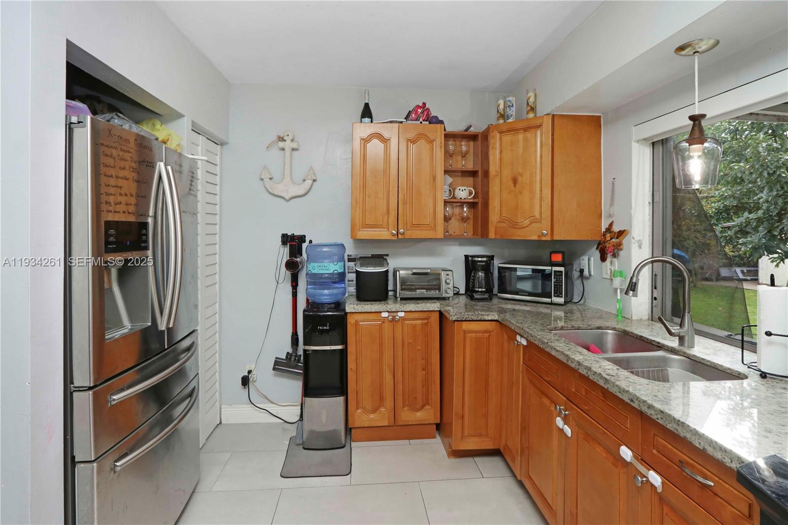 514 Northwest 21st Street Homestead, FL 33030 - Photo 40 of 45 a kitchen with stainless steel appliances granite countertop a refrigerator and a sink