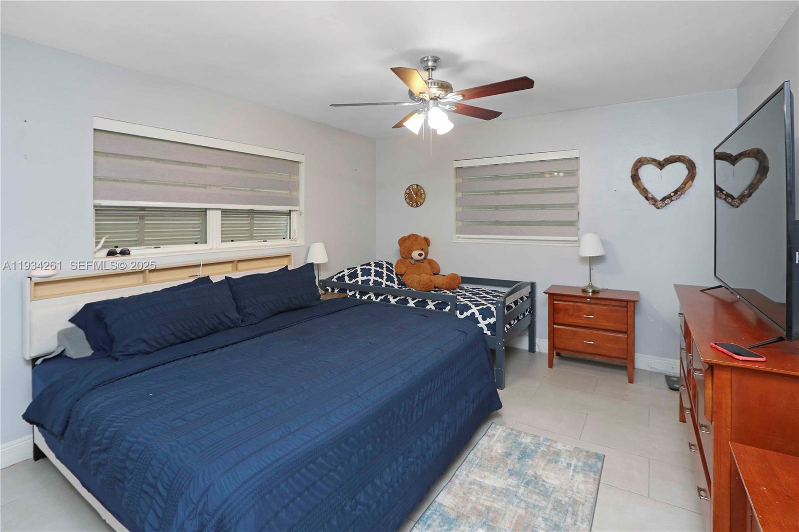 514 Northwest 21st Street Homestead, FL 33030 - Photo 42 of 45 a bed room with a bed and a chandelier