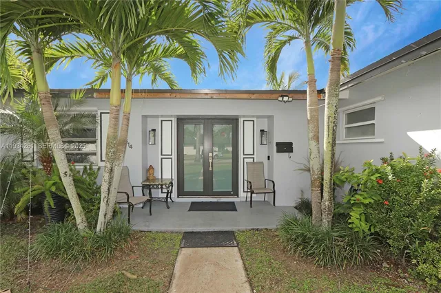 an aerial view of a residential apartment building with a yard and garden space