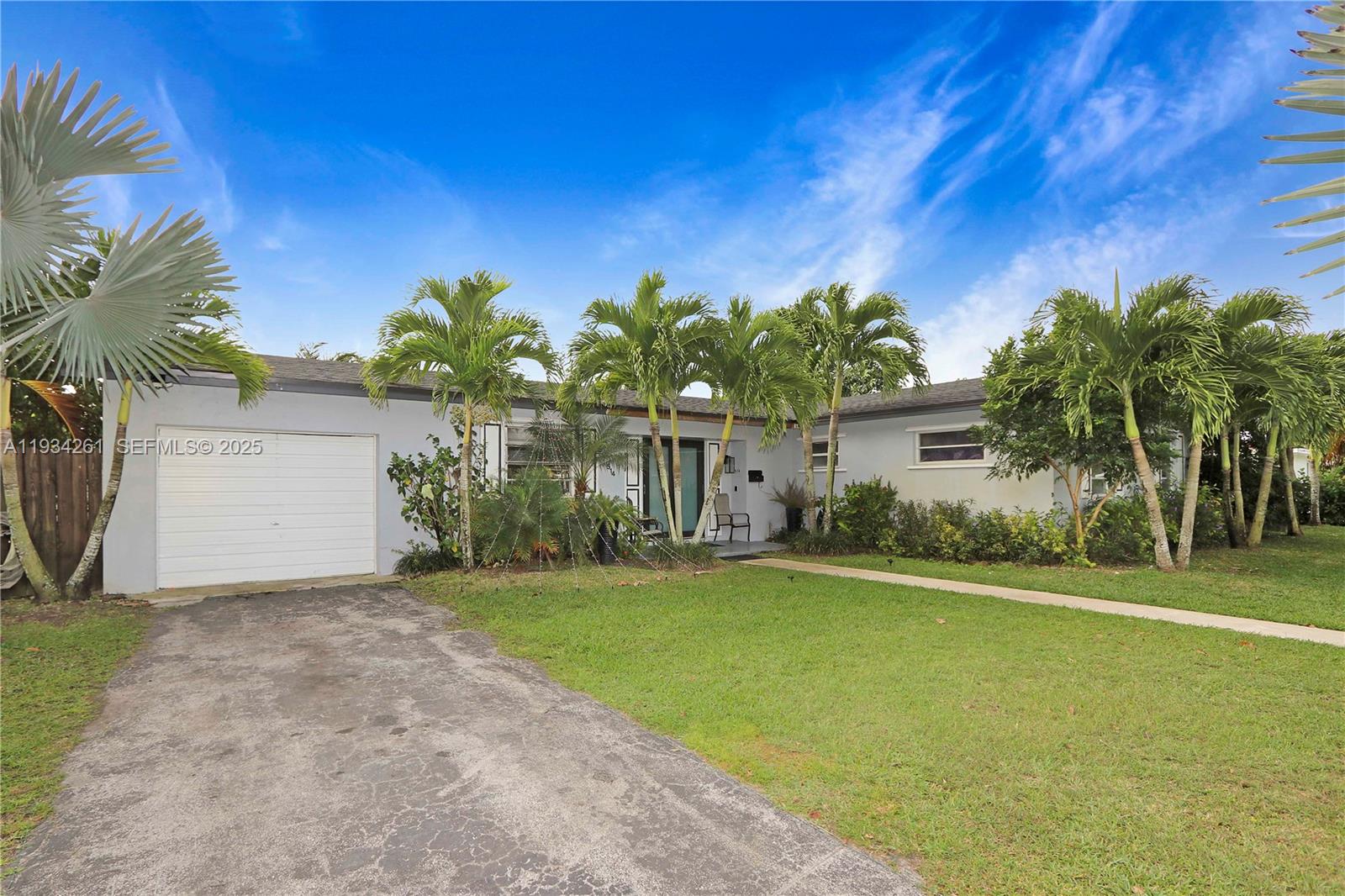 514 Northwest 21st Street Homestead, FL 33030 - Photo 8 of 45 a front view of a house with a yard and garage