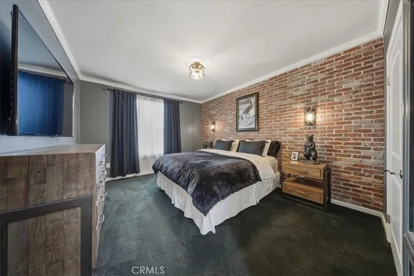 a bedroom with a bed and a view of en suite bathroom