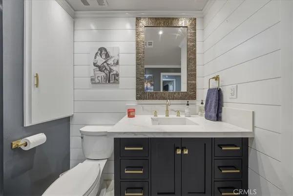 a spacious bathroom with a toilet sink double vanity and a mirror