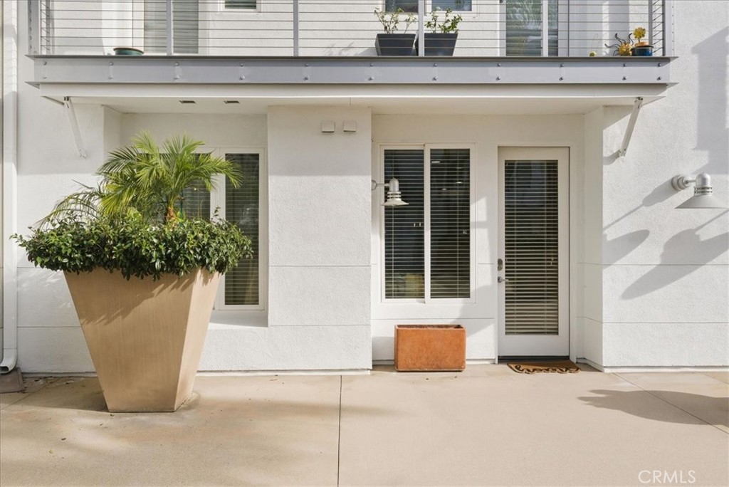1901 Victoria Avenue, Unit 116 Oxnard, CA 93035 - Photo 20 of 31 a white building with glass door and glass door