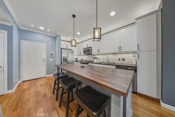 a kitchen with stainless steel appliances a sink stove and refrigerator