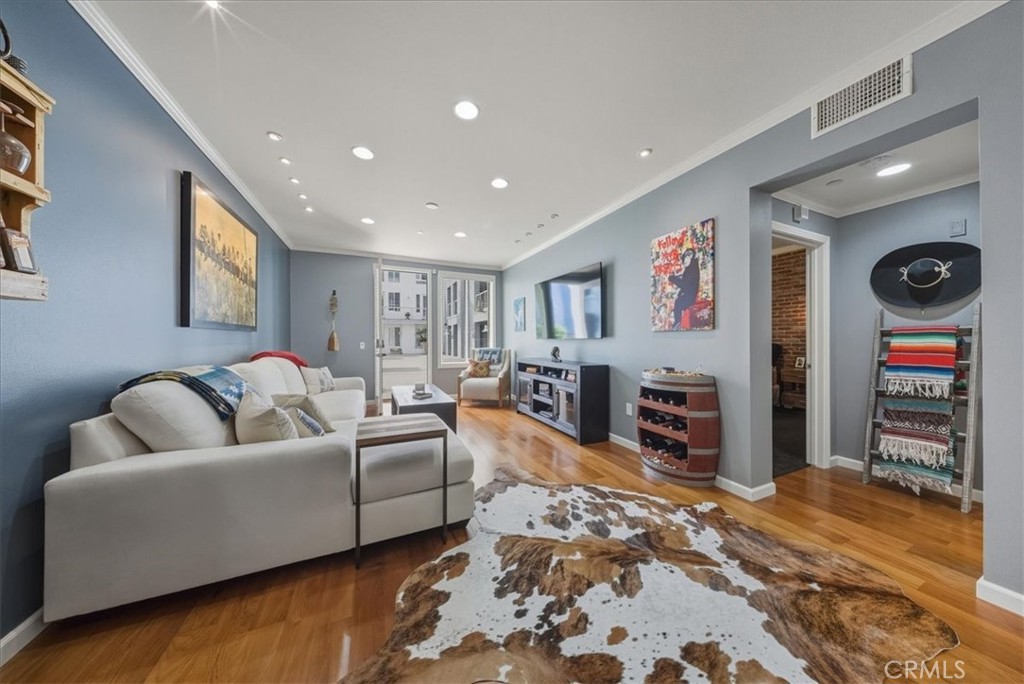 1901 Victoria Avenue, Unit 116 Oxnard, CA 93035 - Photo 8 of 31 a living room with furniture and a flat screen tv