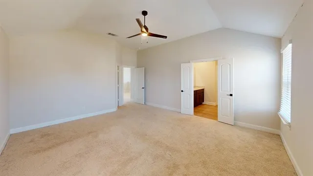 a view of empty room with ceiling fan