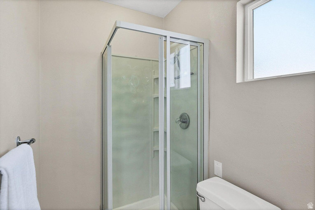 2990 East Riverside Drive, Unit 173 St. George, UT 84790 - Photo 24 of 38 Corner shower enclosure with clear glass doors and a built-in shelf