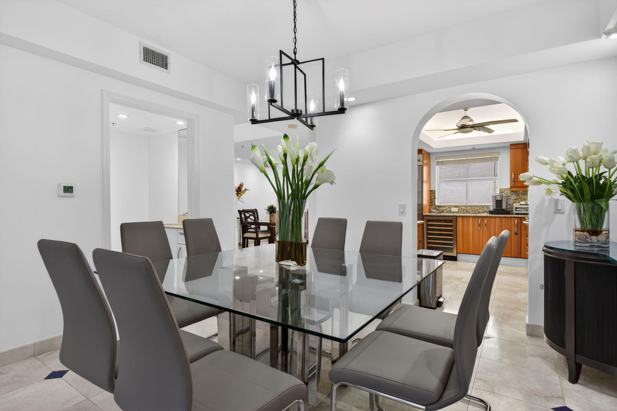2051 Southeast 3rd Street, Unit TH8 Deerfield Beach, FL 33441 - Photo 13 of 58 a view of a dining room with furniture wooden floor and chandelier