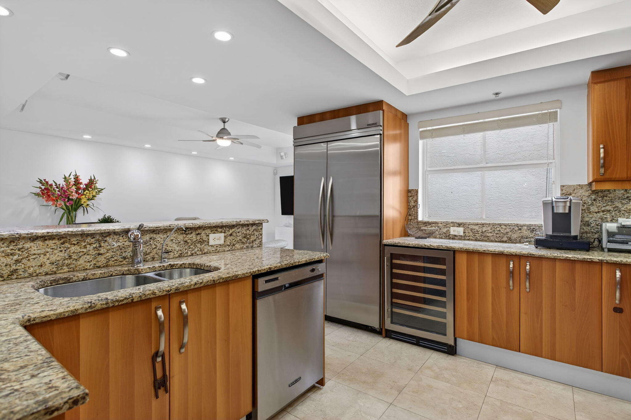 2051 Southeast 3rd Street, Unit TH8 Deerfield Beach, FL 33441 - Photo 17 of 58 a kitchen with stainless steel appliances granite countertop a sink and a refrigerator
