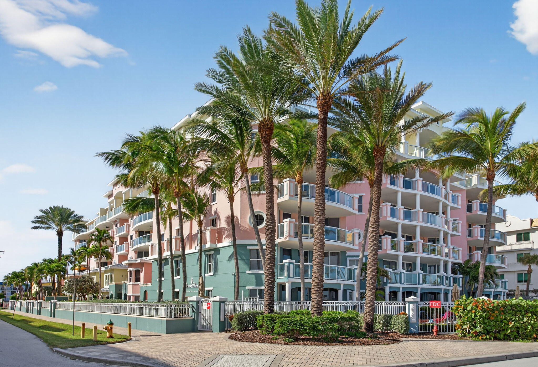 2051 Southeast 3rd Street, Unit TH8 Deerfield Beach, FL 33441 - Photo 3 of 58 a view of a street with a building and palm trees