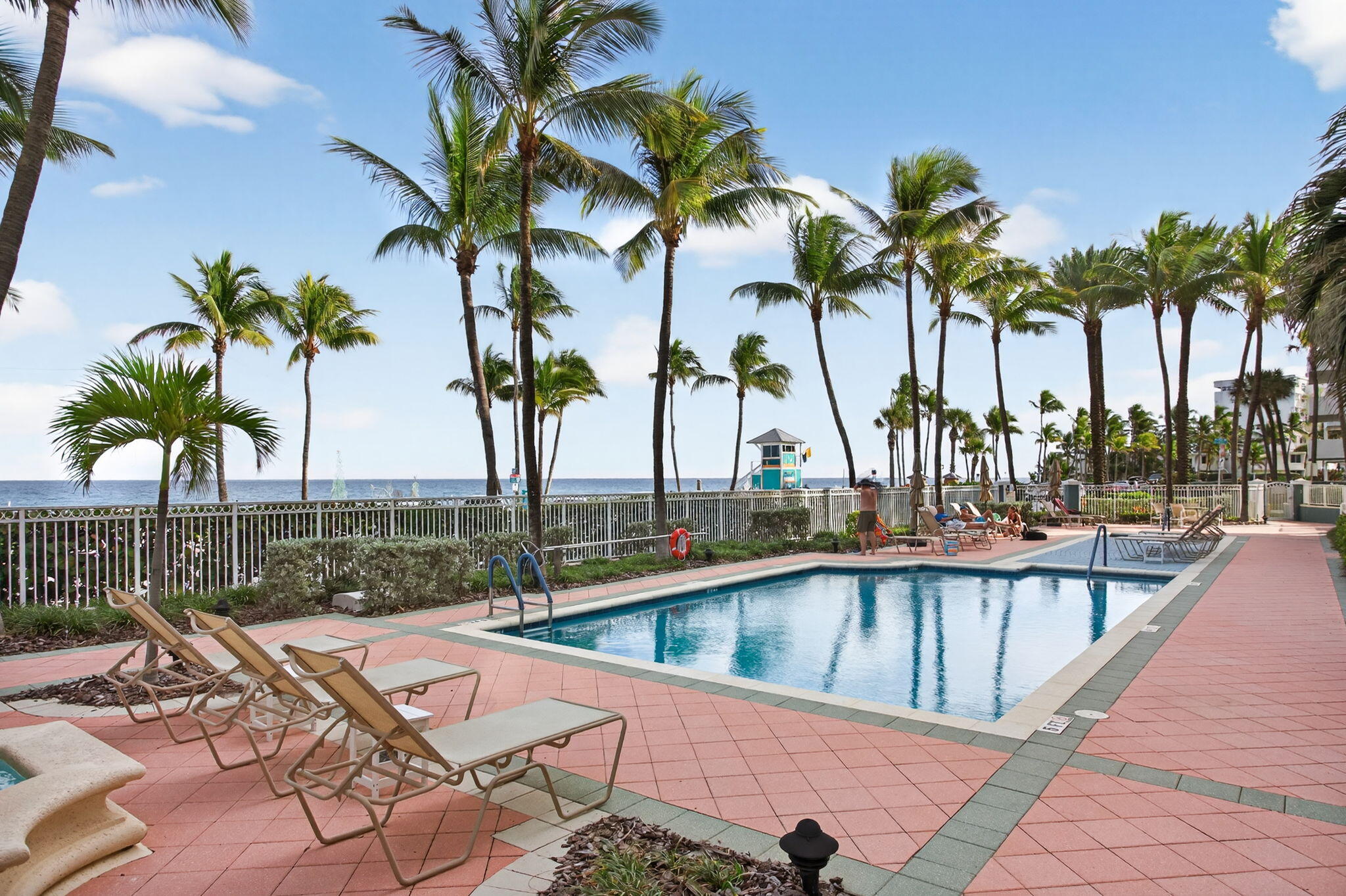 2051 Southeast 3rd Street, Unit TH8 Deerfield Beach, FL 33441 - Photo 46 of 58 a view of a swimming pool with a table and chairs