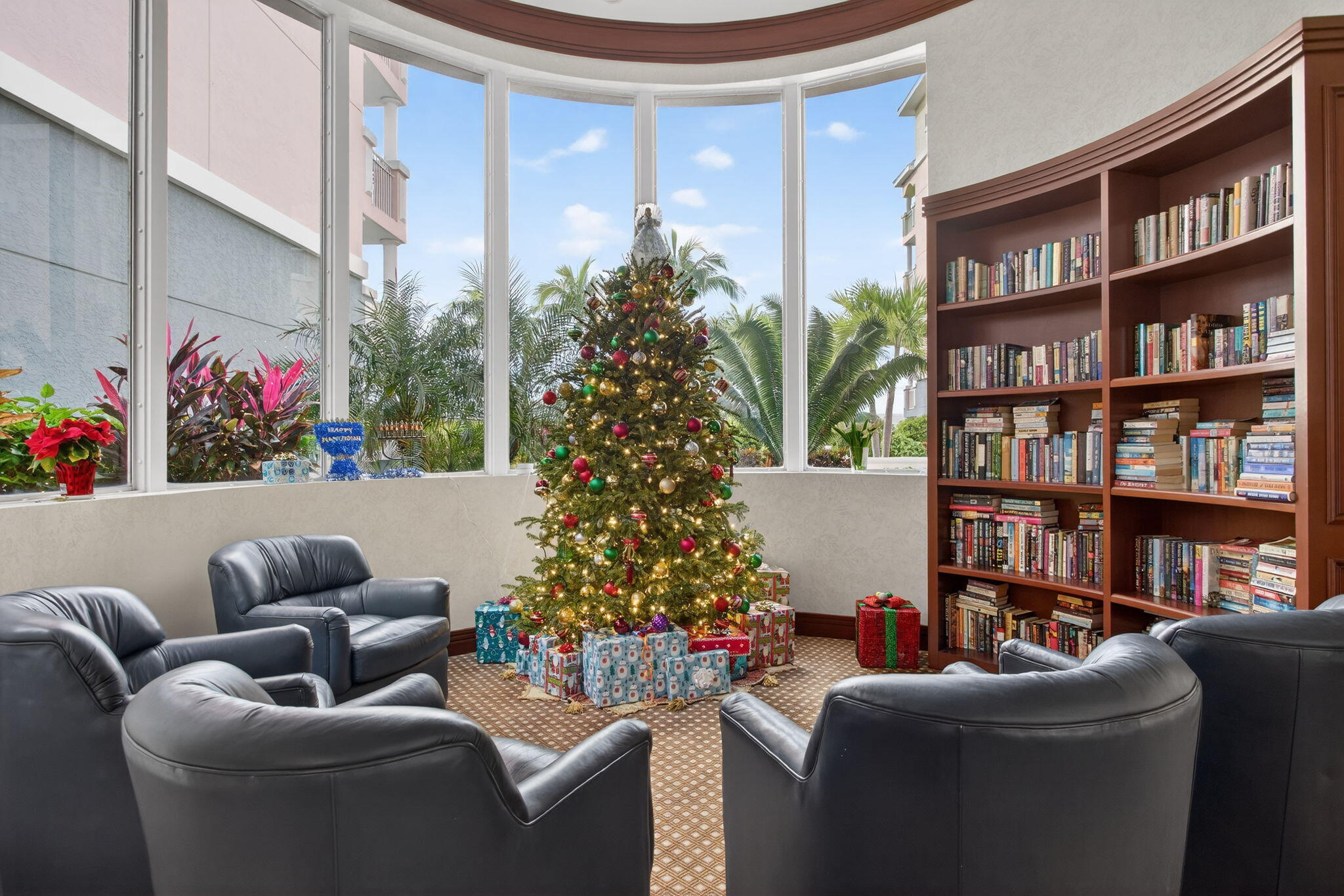 2051 Southeast 3rd Street, Unit TH8 Deerfield Beach, FL 33441 - Photo 50 of 58 a living room with furniture and a potted plant and a book shelf