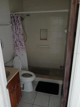 a bathroom with a toilet and a shower