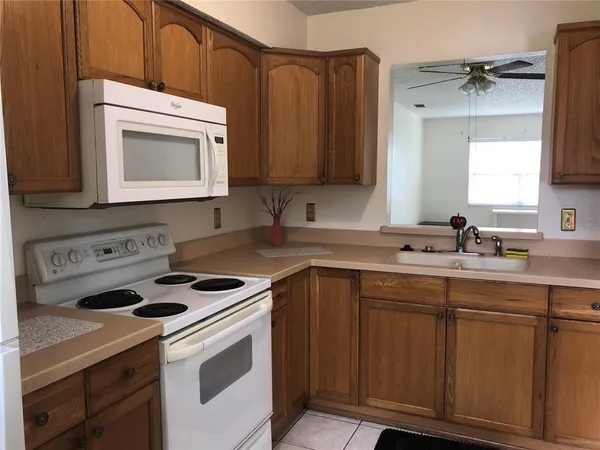 a kitchen with cabinets a sink and appliances