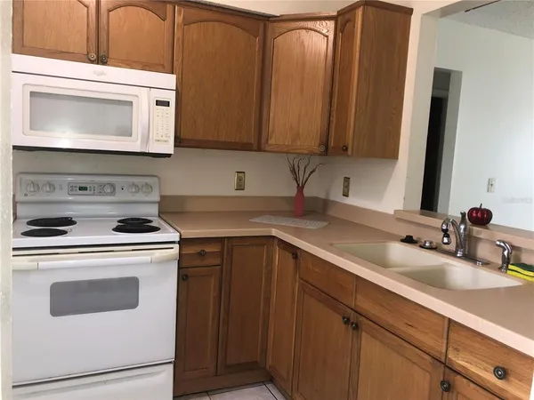 a kitchen with a stove microwave and sink