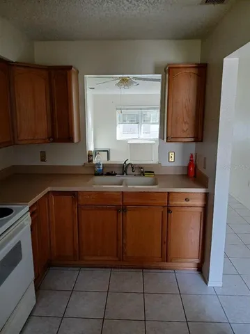 a kitchen with a sink window and cabinets