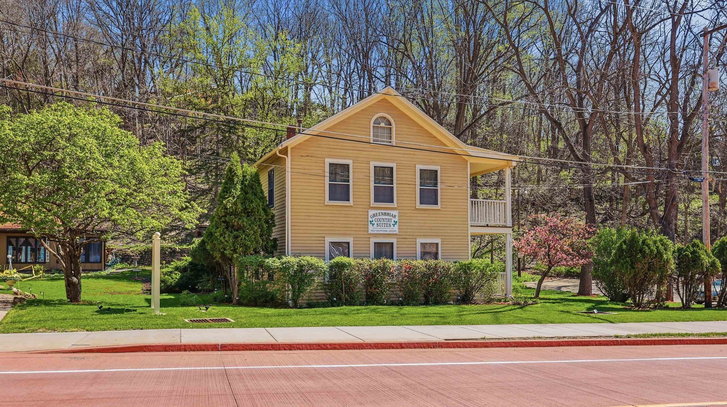 341 Spring Street Galena, IL 61036 - Photo 2 of 35 a front view of a house with a yard and trees