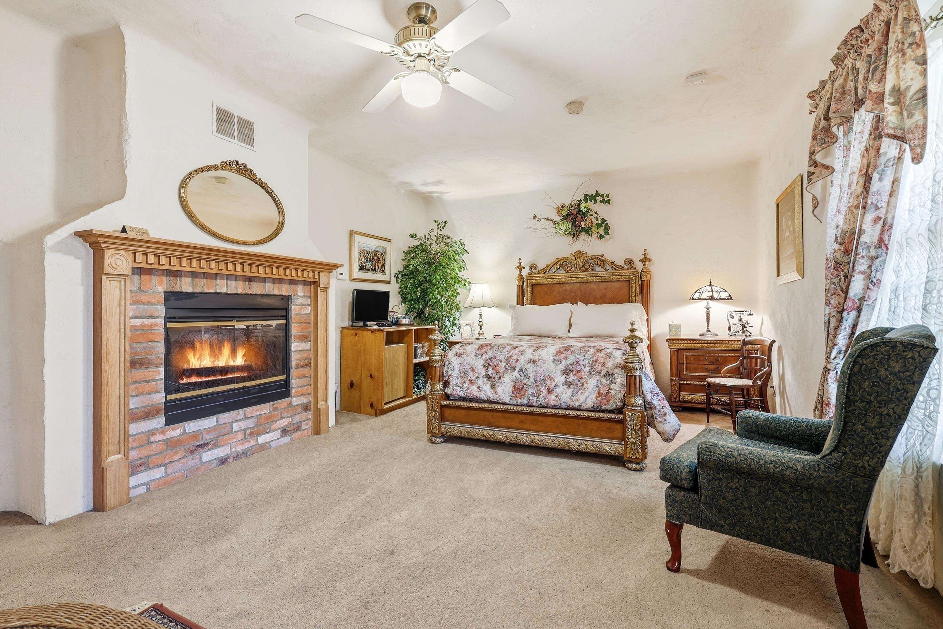 341 Spring Street Galena, IL 61036 - Photo 25 of 35 a bedroom with a bed and a fireplace
