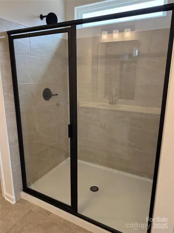 a bathroom with a glass shower door