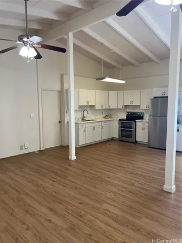 a kitchen with stainless steel appliances granite countertop a refrigerator and a stove top oven
