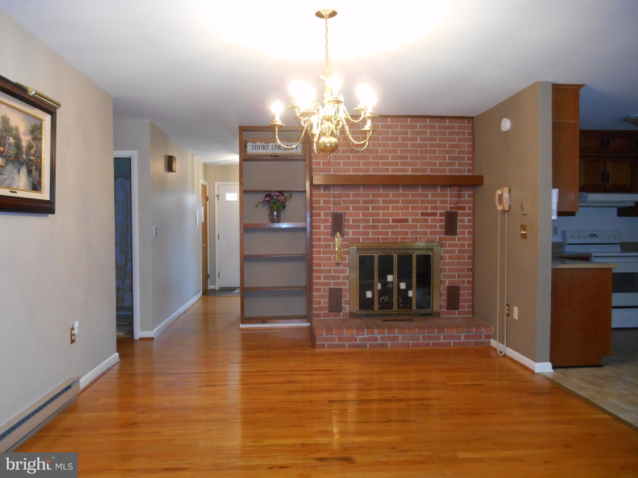 29891 Grasswell Road Easton, MD 21601 - Photo 9 of 29 Dining room with fireplace and built in bookshelf