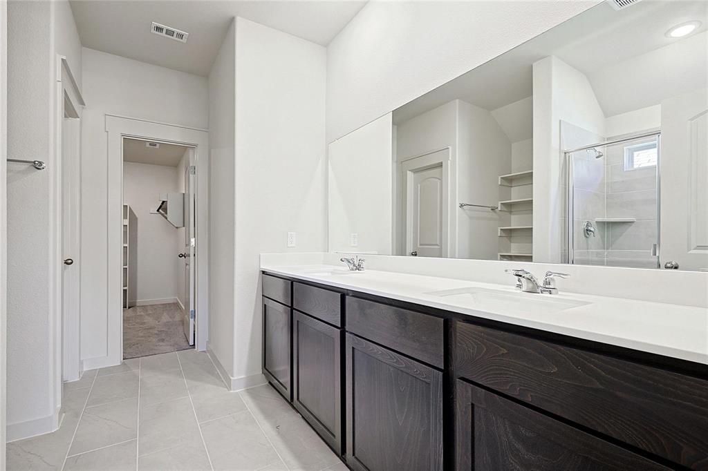 1759 Gleasondale Place Forney, TX 75126 - Photo 14 of 25 Full bath featuring double vanity, a shower stall, light tile patterned flooring, and a spacious closet