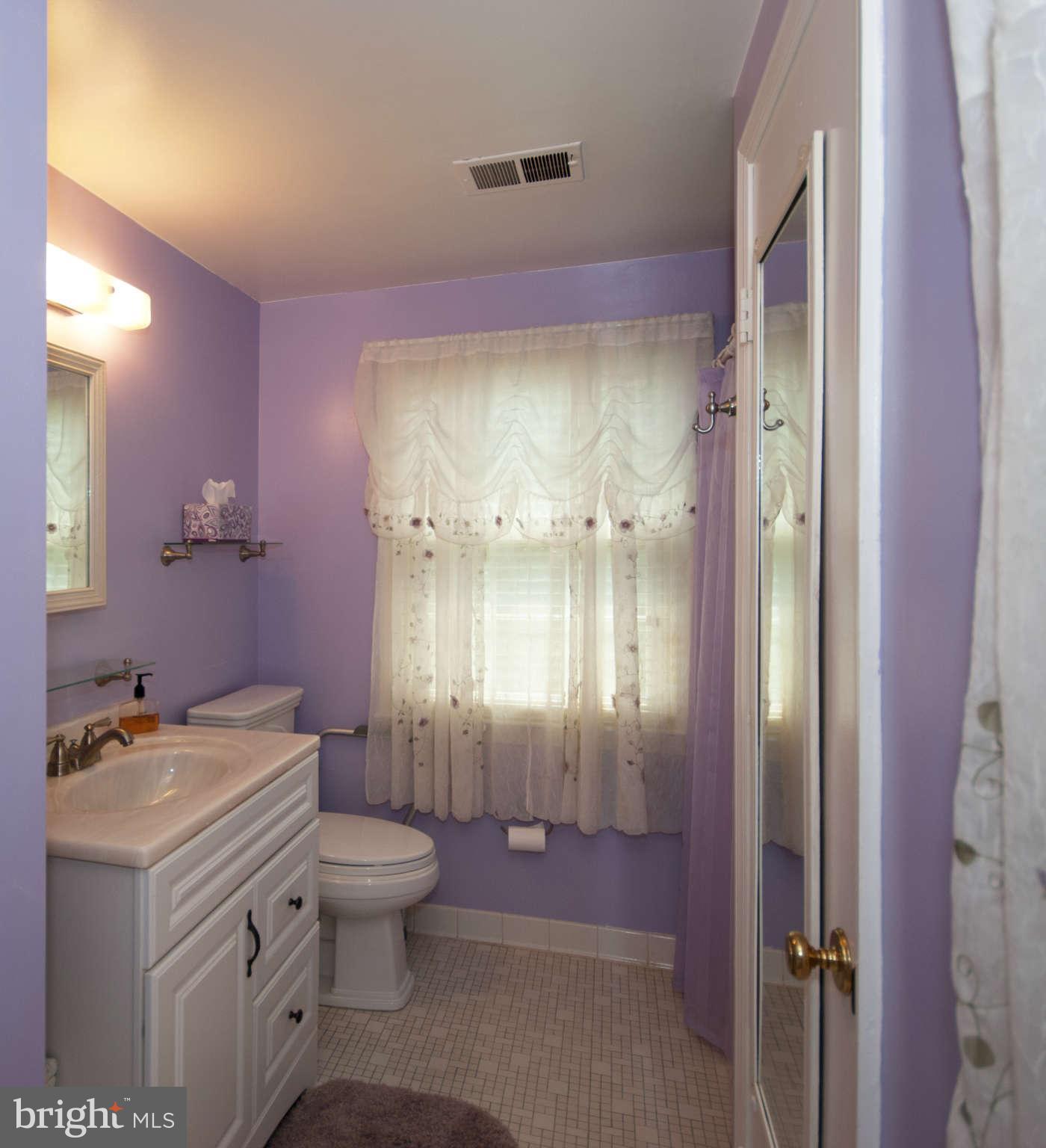 12433 Over Ridge Road Potomac, MD 20854 - Photo 20 of 30 a bathroom with a granite countertop sink a toilet a mirror and shower