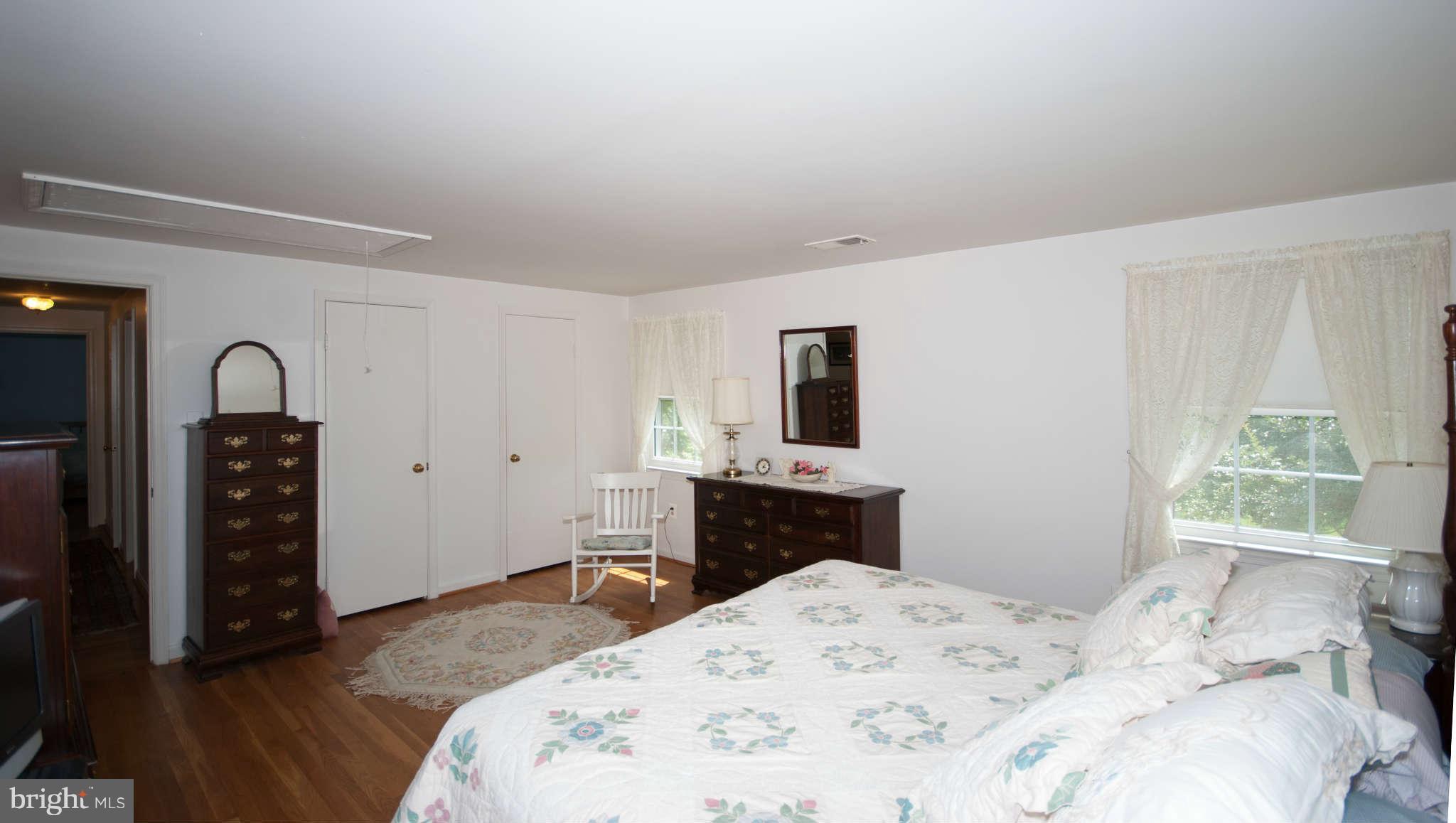 12433 Over Ridge Road Potomac, MD 20854 - Photo 21 of 30 a bedroom with a bed and a flat screen tv