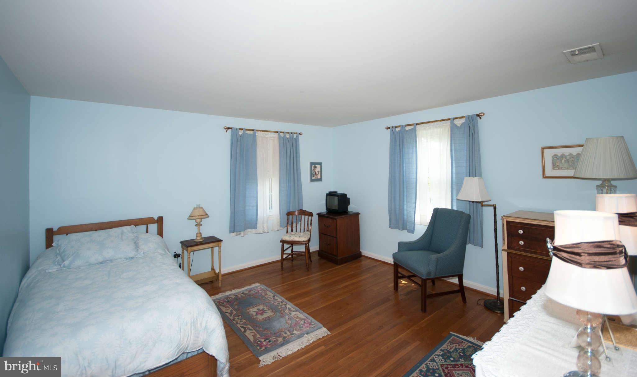 12433 Over Ridge Road Potomac, MD 20854 - Photo 22 of 30 a bedroom with furniture and a wooden floor