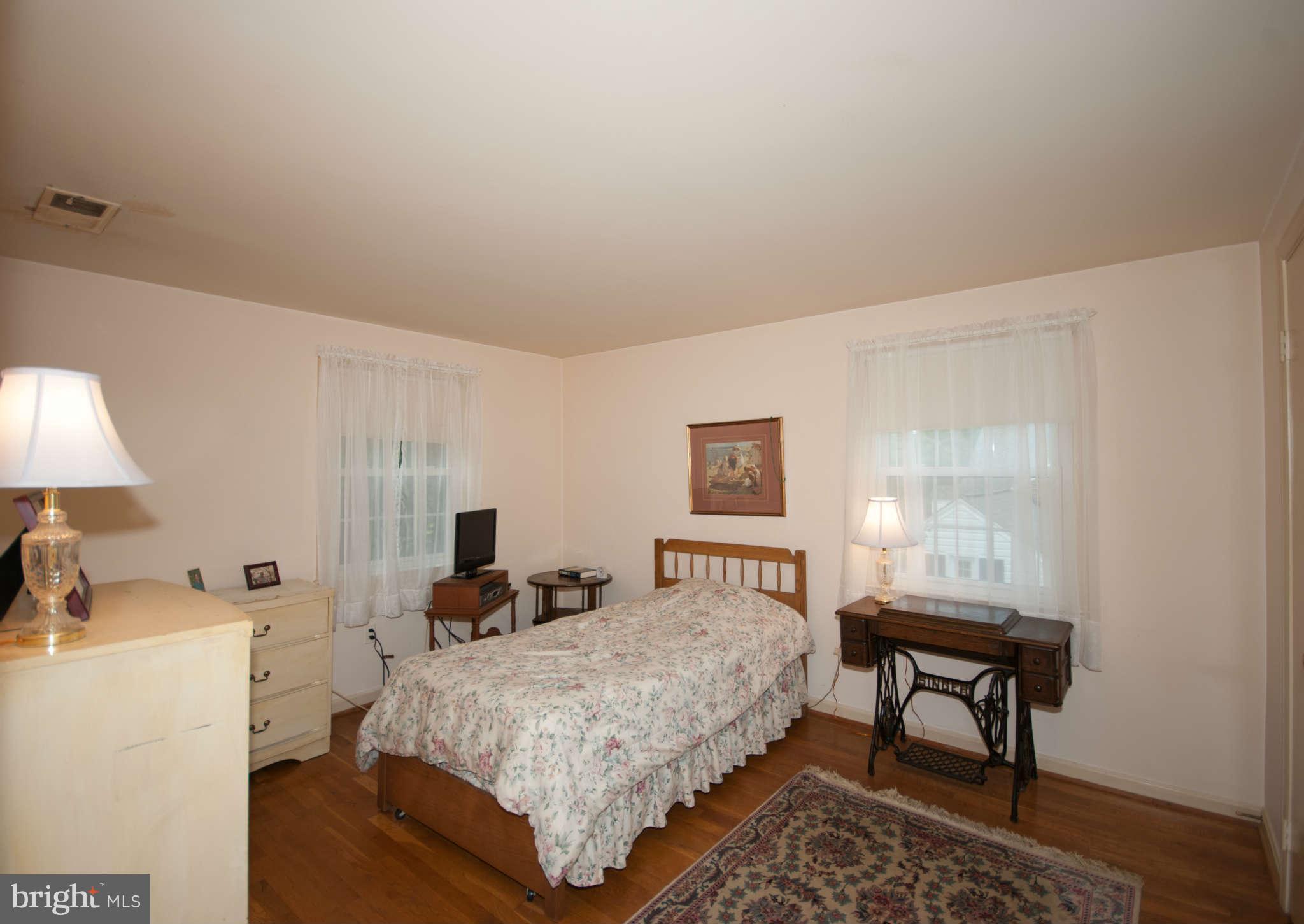 12433 Over Ridge Road Potomac, MD 20854 - Photo 23 of 30 a bedroom with a bed a table and chair