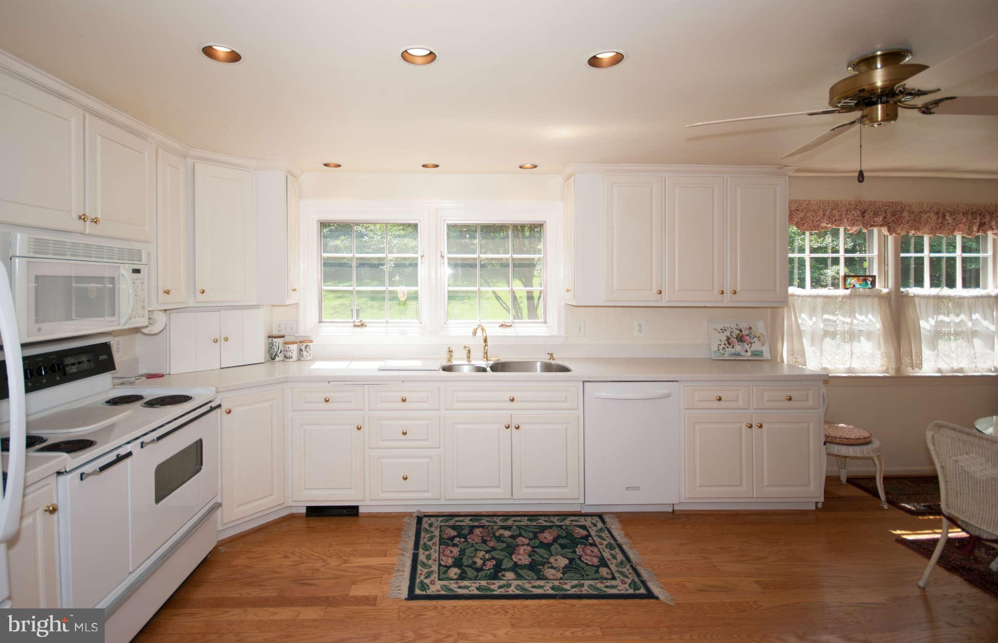 12433 Over Ridge Road Potomac, MD 20854 - Photo 7 of 30 a kitchen that has a sink and a stove in it
