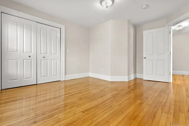 a view of an empty room and wooden floor