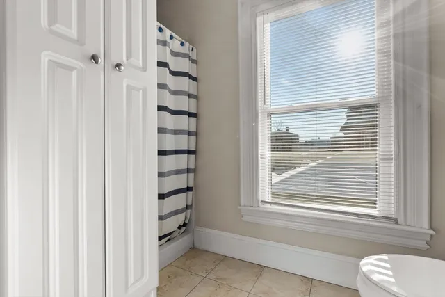 a bathroom with a bathtub and window