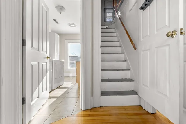 a view of a hallway view with wooden floor and staircase