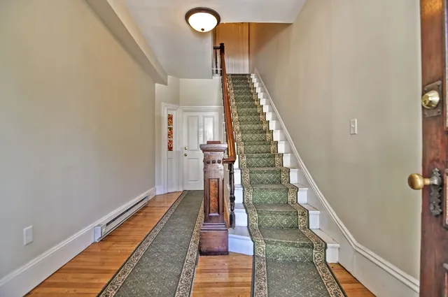 a view of entryway and hall with wooden floor