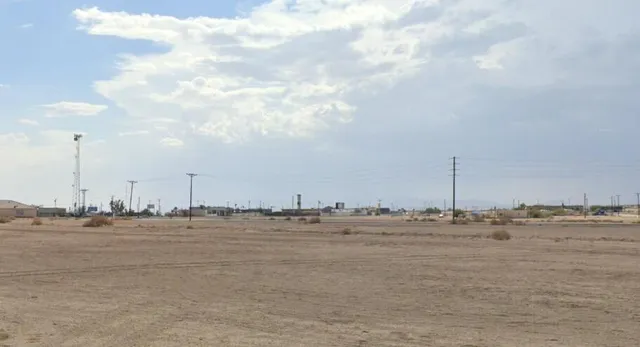 a view of a beach with a large mountain