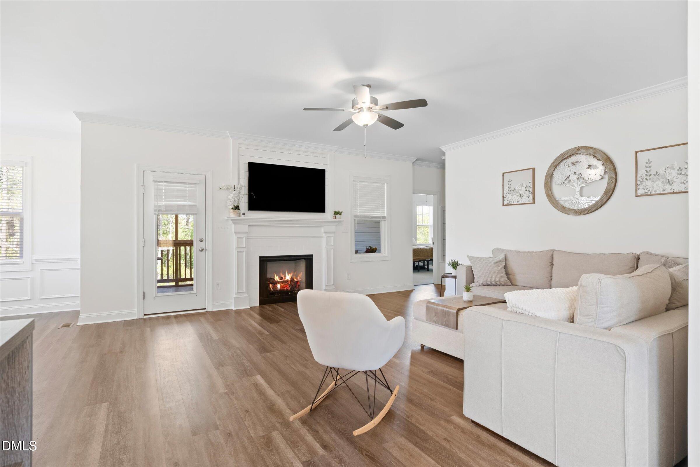 116 Nairn Street Fayetteville, NC 28311 - Photo 10 of 56 a living room with furniture a fireplace and a flat screen tv