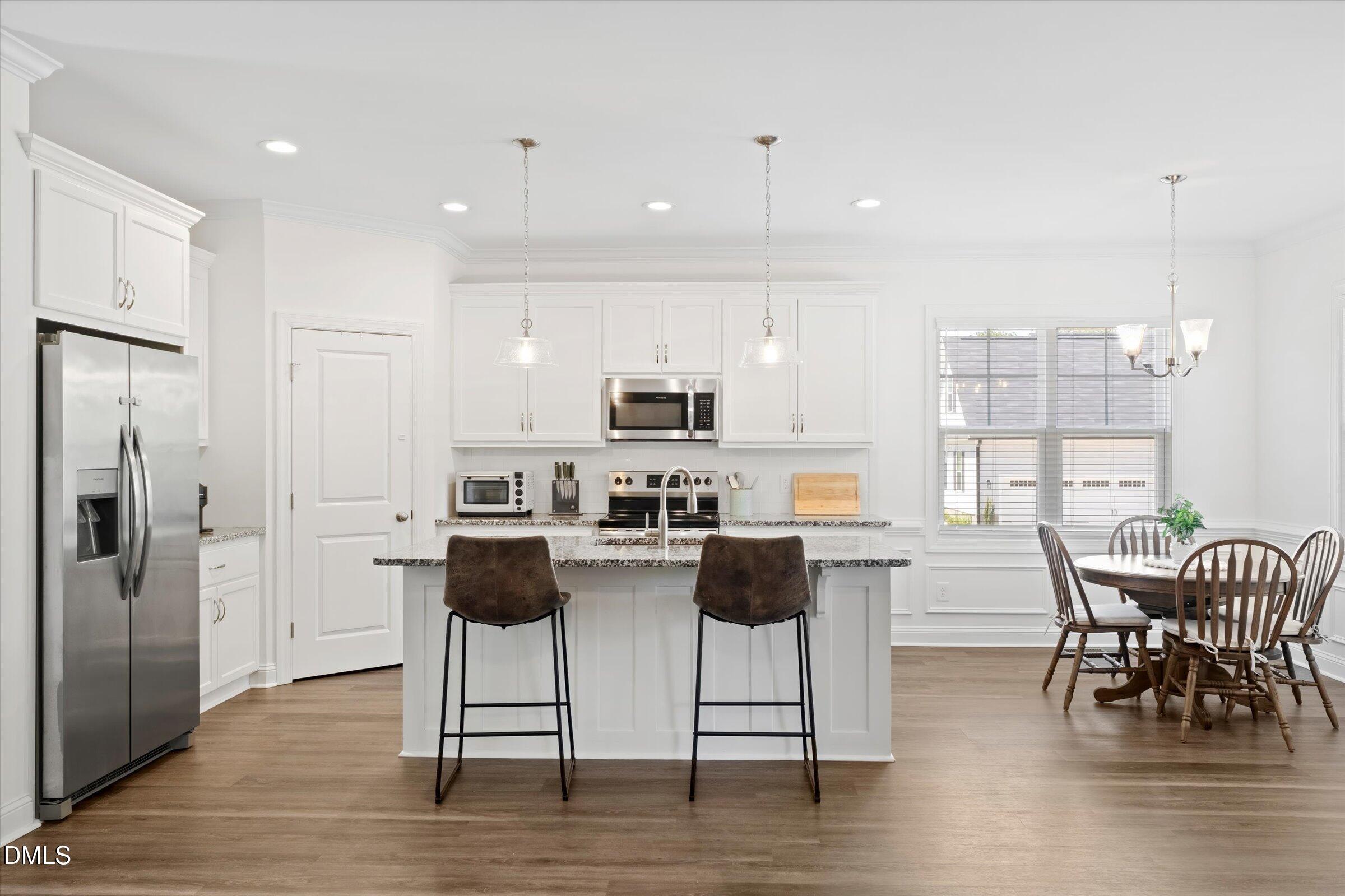 116 Nairn Street Fayetteville, NC 28311 - Photo 13 of 56 a kitchen with stainless steel appliances kitchen island granite countertop a dining table chairs and granite counter tops